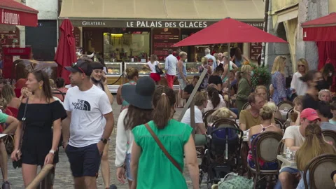 Tourists strolling through the ancient streets of the old town of Annecy Stock Footage 159984794
