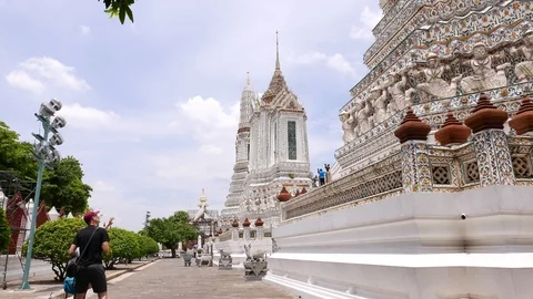 Tourists study decorated walls and towers Buddhist temple, Wat Arun, Bangkok Stock Footage 90216914