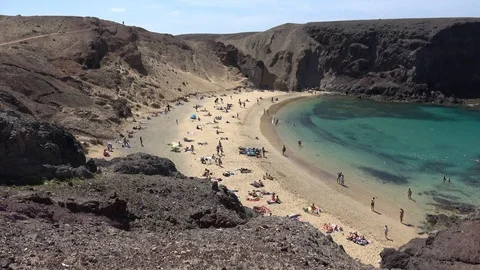 Tourists sunbathing on the beach in Playa de Papagayo Lanzarote Spain Video stock 88120596