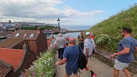 Tourists taking on the infamous 199 steps in the seaside town of Whitby Stock-Footage 247345422