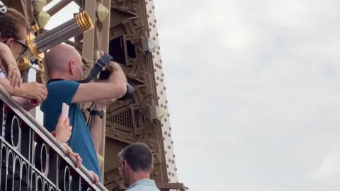 Tourists taking a panoramic photo from Eiffel Tower observation deck in Paris Stock-Footage 334133954