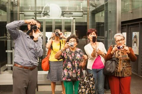 Tourists taking pictures in museum Stock Photos
