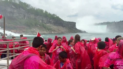 Tourists Taking Pictures While Sailing Past American Side of Niagara Falls Stock Footage 91636992