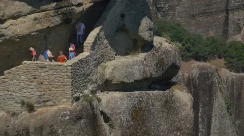 Tourists taking pictures while visiting the Holy Trinity Monastery in Meteora Stock Footage 66313647