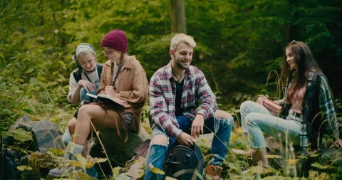 Tourists Taking Rest While Sitting On Rocks In Forest Video stock 251987106