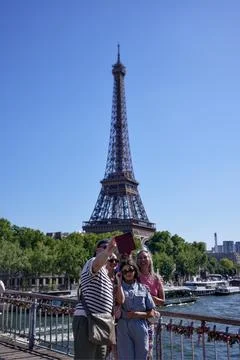Tourists taking selfie in front of Eiffel Tower in Paris, France on May 30, 2025 Stock Photos
