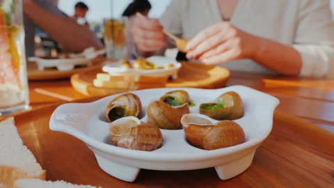 Tourists taste snails - an exquisite dish of French cuisine Stock Footage 139802271