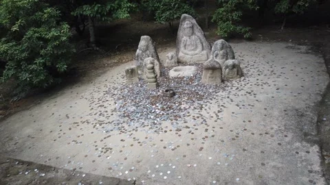 Tourists Throwing Coins for Good Luck Wishes at Stone Buddha Statues in Stock Footage 342296911