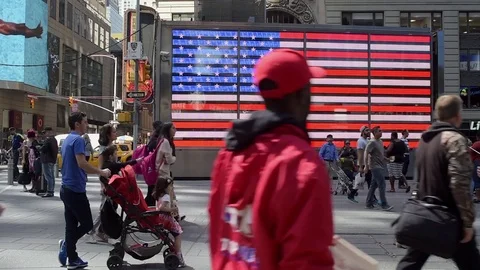 Tourists in Times Square Pose &amp; Pass By Large, American (USA) Flag Stock Footage 74701063