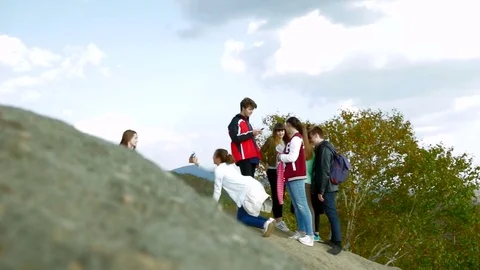 Tourists on top of the mountain  Видео 77705904