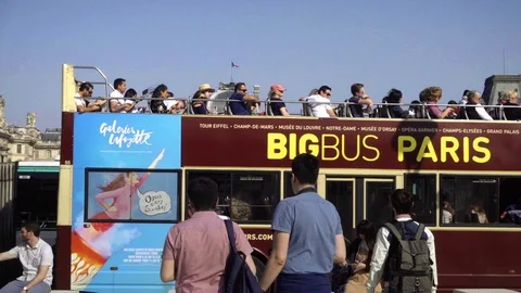 Tourists on tour - red double-decker Big Bus - departing Pyramid of Louvre Paris Stock Footage 94065984