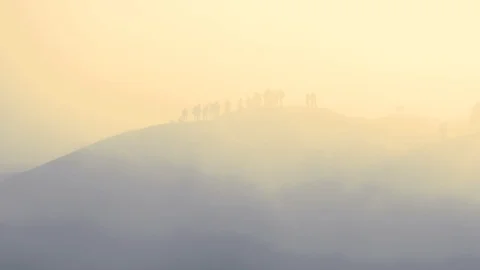Tourists trekking an active volcano surrounded by mist at sunrise a time-lapse Stock Footage 93840601