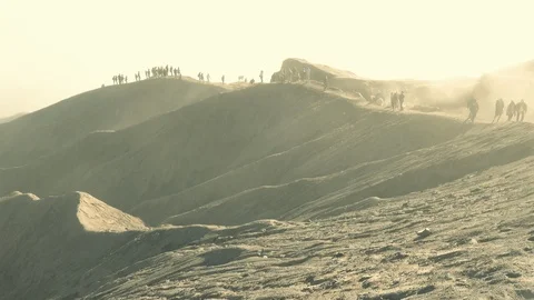 Tourists trekking an active volcano surrounded by mist at sunrise a time-lapse Stock Footage 93841673