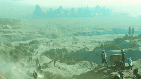 Tourists trekking an active volcano surrounded by mist at sunrise a time-lapse Stock Footage 93842411