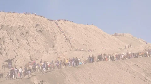 Tourists trekking an active volcano surrounded by mist at sunrise a time-lapse Stock Footage 93843660