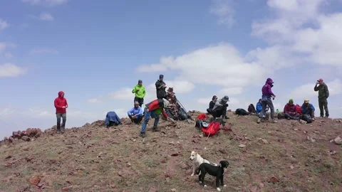 Tourists with two dogs at a rest stop on the crest of the Red Katya mountain Stock-Footage 210195492
