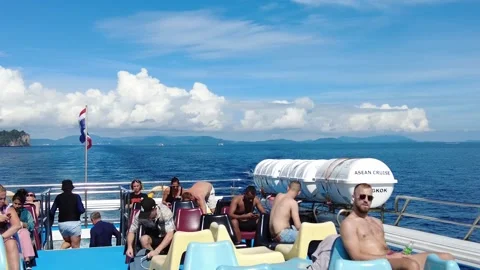 Tourists on the upper deck enjoy the sea journey to the islands. Stock Footage 323258759