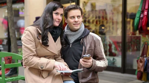Tourists using map and smartphone in city Stock Footage 33080885