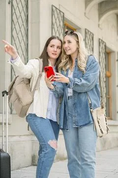 Tourists using mobile to get directions in the city Stock Photos