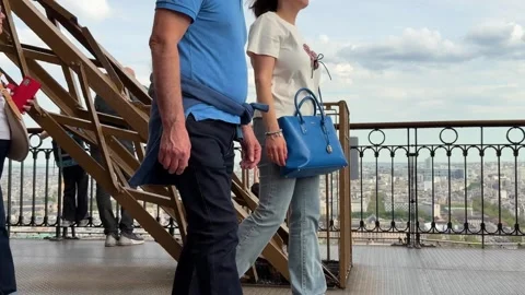 Tourists viewing city panorama from Eiffel Tower observation deck Stock Footage 334133984