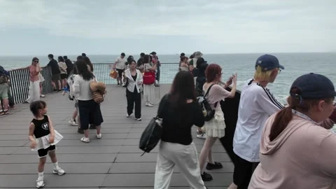 Tourists on Viewing Deck Overlooking Ocean Cliffs at Jeju Island, South Korea Stock Footage 341180539