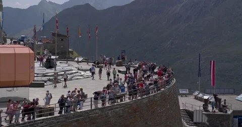 Tourists at viewpoint watching glacier on mountain top Stock Footage 79900116