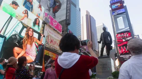Tourists visit Times Square surrounded by advertising screens in New York Stock Footage 50522208