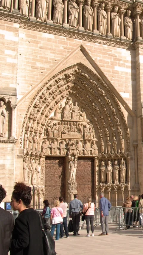 Tourists Visiting the Gothic Facade of Notre Dame Cathedral in Paris 스톡 동영상 344104461