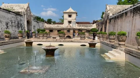 Tourists visiting the historic bathing pool area of Taman Sari Water Castle. Video stock 342984473