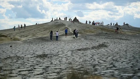 Tourists visiting mud volcanoes also known as mud domes in summer season 스톡 동영상 77358993