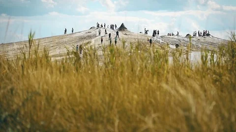 Tourists visiting mud volcanoes also known as mud domes in summer season Vídeo Stock 77359119