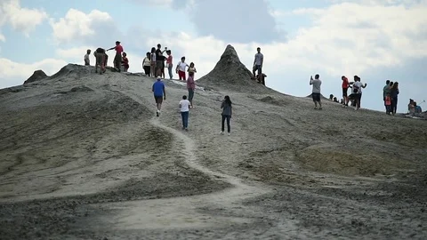 Tourists visiting mud volcanoes also known as mud domes in summer season 스톡 동영상 77359135