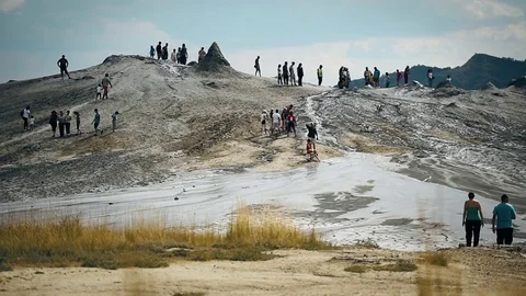 Tourists visiting mud volcanoes also known as mud domes in summer season 動画素材 77359144