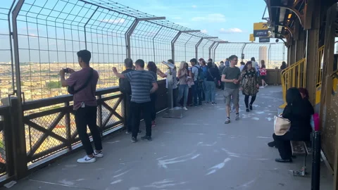Tourists visiting the second floor of the Eiffel Tower in Paris, France Stock Footage 196153899