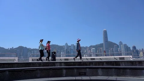 Tourists visiting the Tsim Sha Tsui Promenade in the morning Stock Footage 125401697