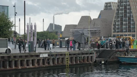 Tourists wait on pier to board a small boat docking at Copenhagen quay stairs Stock Footage 345499852