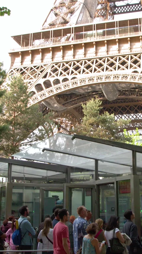 Tourists Waiting in Line at the Eiffel Tower Security Entrance in Paris Stock Footage 334831321