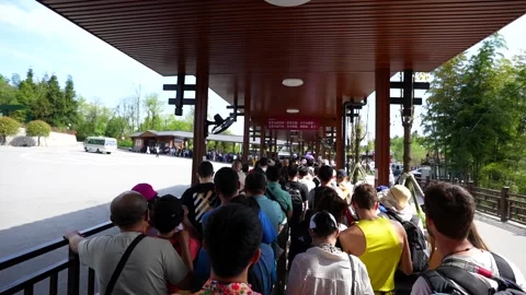 Tourists waiting in long queue for a bus at Zhangjiajie park Stock Footage 341658437