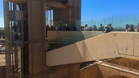 Tourists Waiting For Outdoor Elevator On Stone Bridge With Glass Railings Stock Footage 317779997