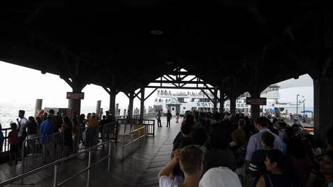 Tourists waiting in queue at Pier on Liberty Island in New York Stock Footage 93473983