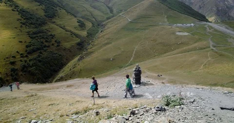 Tourists walk along a mountain path Stock Footage 121635170
