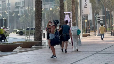 Tourists walk along the pedestrian path in Downtown. Dubai UAE 2 September 2026. Stock Footage 344964391