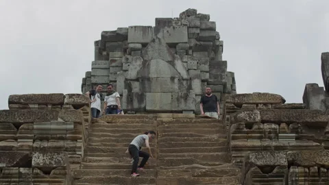 Tourists walk down the  steps,Ta Keo Shiva temple, Angkor, Siem Reap, Cambodia Stock Footage 134499424