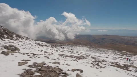 Tourists walk down from the summit of Mount Aragats in Armenia. Stock Footage 316385801