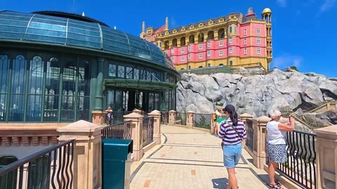 Tourists walk by Eclipse Plaza and Lava Castle at Ba Na Hills Da Nang Vietnam Stock Footage 332458020
