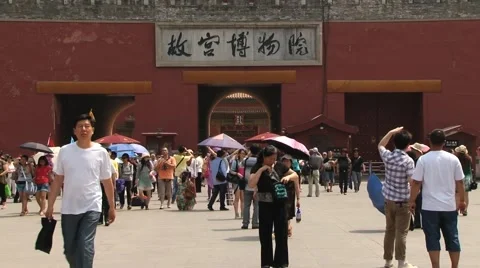 Tourists walk in front of the gate of the Gugun palace in Beijing, China. Stock Footage 66765126