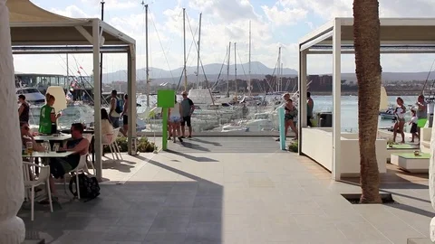Tourists walk passed harbor side restaurants Stock Footage 85063832