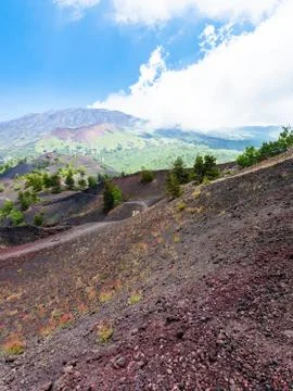 Tourists walk on path between old crater Stock Photos