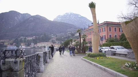 Tourists walking  along Como lakeside path. Stock Footage