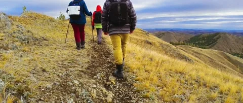 Tourists walking along the path on the top of the mountain Stock Footage 218449909